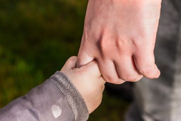 A close up of two hands holding each other